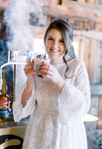 Smiling winter bride sipping Hot Cocoa in front of Espresso Dave Coffee Catering espresso cart manuela mejia photography