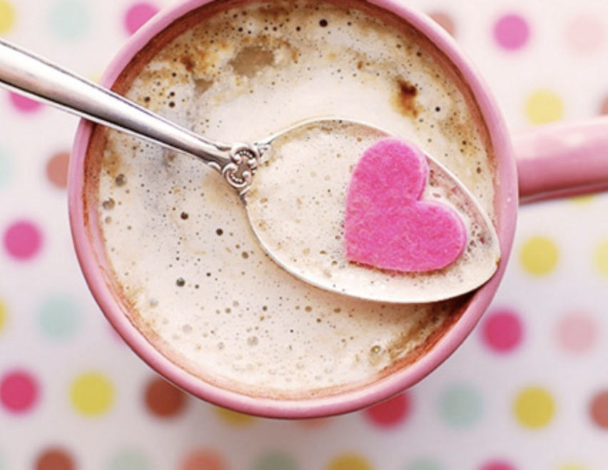 A Coffee Lover's favorite: cappuccino with spoon full of foam and pink sugar heart